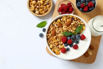 Delicious granola with berries and yogurt on a light background