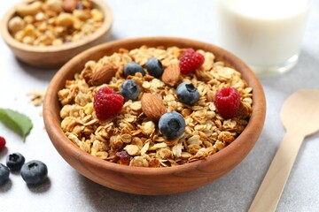 Delicious granola with berries on a light background