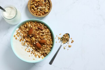 Delicious granola with yogurt on a light background