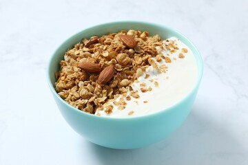 Delicious granola with yogurt on a light background
