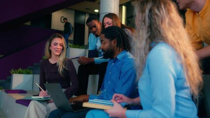 Collaborative learning moment capturing diverse university students working together on academic project, sharing ideas and using technology while sitting on steps in slow motion - Powered by Adobe