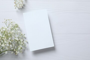 Top view photo with gypsophila flowers with paper card on white background 