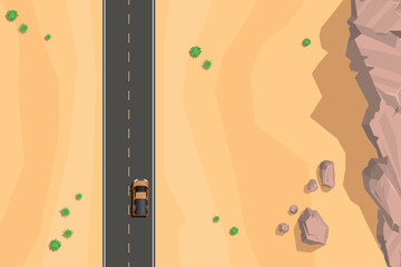 Top view of a desert landscape with a straight asphalt road, yellow dashed lines, and a lone car. Surrounded by sandy terrain, sparse green bushes, and scattered rocks. Aerial. View from above. © Алексей Шпадарук