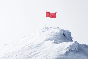 Red flag atop snowy mountain peak signifying achievement, success, and victory.