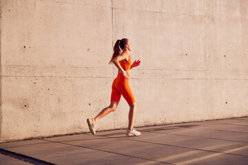 Fit woman jogging outdoors in urban environment