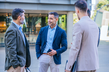 Group of Businessmen Talking Outdoors in a Casual Meeting
