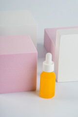 Plastic yellow tube for cream or lotion. Skin care or sunscreen cosmetic with stylish props on white background.