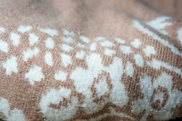 Delicate patterns of a handcrafted textile in warm earthy tones