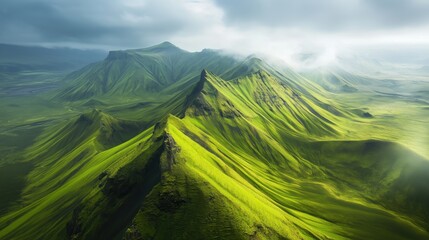 Fototapeta premium The verdant mountains stretch endlessly, their vibrant hues contrasting beautifully with the soft, textured clouds above, offering a serene and awe-inspiring view.