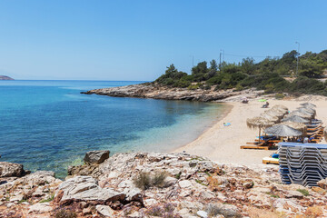 Crystal-clear waters gently flowing over a rocky beach in Thassos, Greece, showcasing natural coastal beauty.