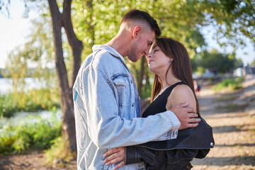 Stylish and young man and woman posing on the street,