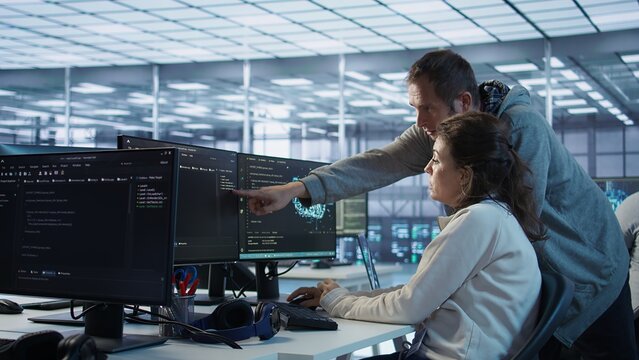 IT technicians in server farm brainstorming ways to repair equipment storing datasets. Colleagues at work in data center discussing how to mend rigs doing computational operations, camera B