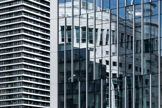 This image features a fascinating juxtaposition of modern structures reflecting classical architectural elements, revealing a dialogue between historical and contemporary design.