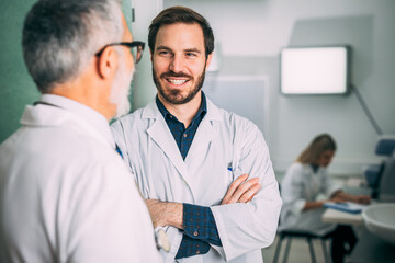 Obraz premium Portrait of young doctor who listens to the advice of his experienced colleague.