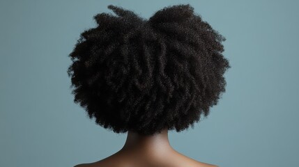 Afro curly hair with tight, voluminous coils styled into a bold and natural shape, celebrating texture and individuality
