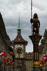 Naklejka premium The Zähringerbrunnen was built in 1535 as a monument to the founder of Bern. The armored bear bears a shield and a banner, both emblazoned with the Zähringe lion. In the background is the astronomica