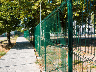 Metal fence made of mesh with rectangular cells