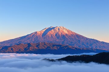 Fototapeta premium Majestic snow-capped mountain against vibrant sunset sky over serene landscape in early evening. Beautiful simple AI generated image
