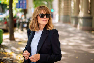 Mid aged blond woman walking on the street