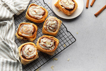 Freshly baked cinnamon rolls cooling on a wire rack