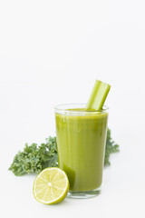 Green Detox Juice with Kale, Lemon, Celery, and Apple on White Background