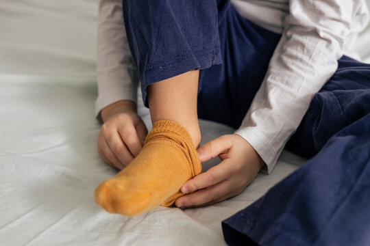 sitting on white bed, getting ready for bedtime or playtime