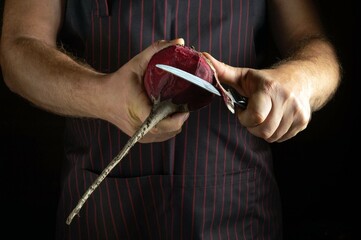 Hands expertly peel red beets, demonstrating the meticulous cutting process. The emphasis on the knife and beetroot underscores the dedication to culinary craftsmanship