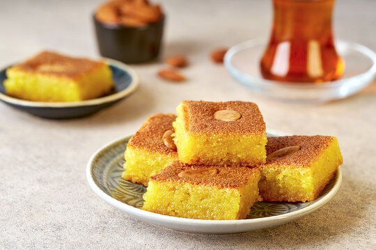 Middle eastern traditional semolina cake basbousa , namoora, hareesa served with tea
