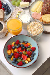 Assortment of various breakfast foods and drinks on the white table. Selective focus.