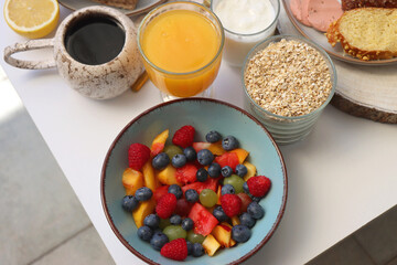 Assortment of various breakfast foods and drinks on the white table. Selective focus.
