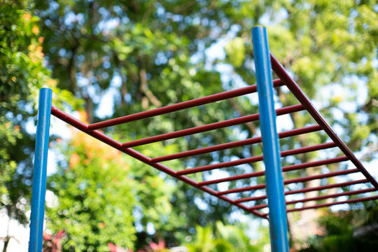 A monkey bar exercise equipment in an outdoor park ready for use