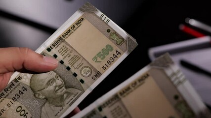 Sion, Maharashtra, India-June 5th-2024-Close static shot of counting Indian 500 rupee notes with naked hands.