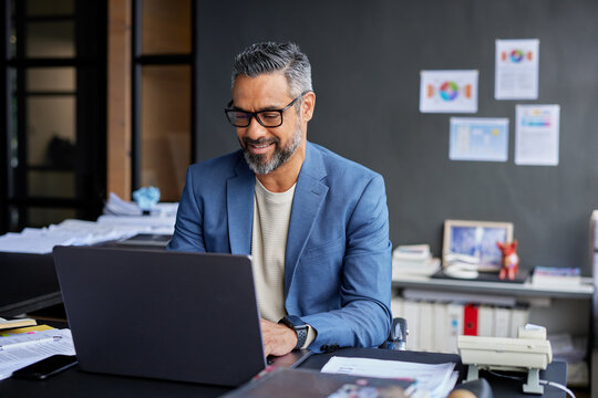 Successfull middle eastern man using laptop at work