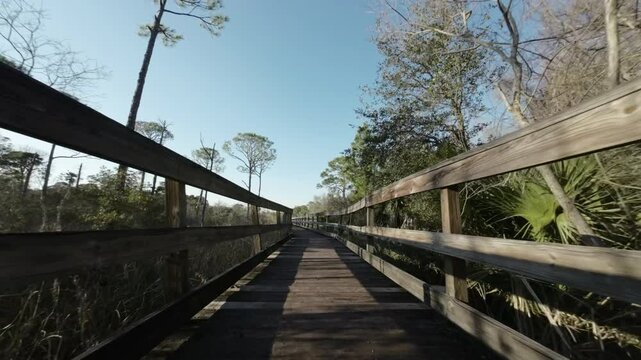Drone shot along wooden path at Mattie Kelly Park and Nature Walk in Destin