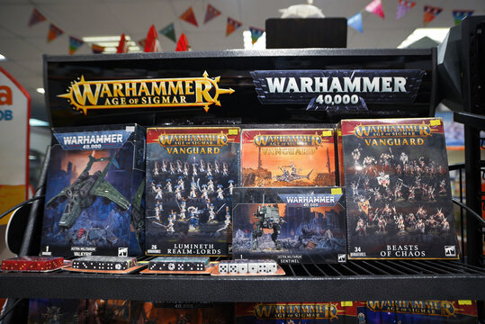 Minsk, Belarus. Nov 8, 2024. Store shelf with Warhammer 40,000 and Age of Sigmar boxed sets, dice, and game pieces. Warhammer 40000 games on display. Tabletop war gaming collection featuring Warhammer
