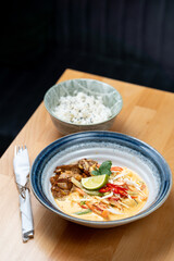 asian style lunch dish of protein tempeh chicken vegetable sauce rice side dish fresh lime garnish