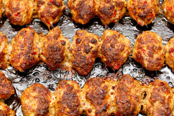 A plate of meat is cooked and has a crispy texture