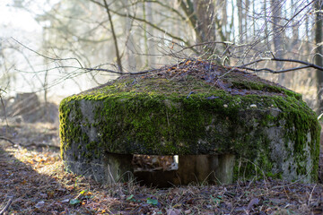 Obraz premium Betonowy mały obiekt w kształcie bunkra stanowiący ochronę żołnierza przed ostrzałem nieprzyjaciela