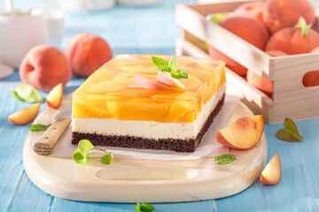 Tasty jelly peach cheesecake made with fruits, jelly and foam.
