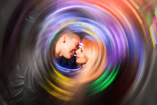 Colorful abstract swirl frames intimate moment of a lesbian couple