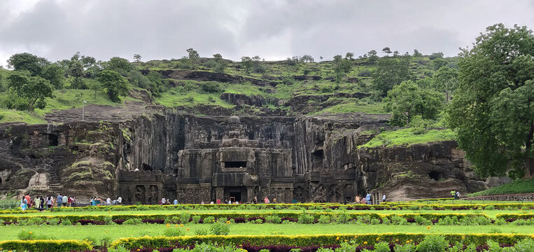 A large building with a lot of people standing in front of it. Kailasa Temple, Ellora Caves, India