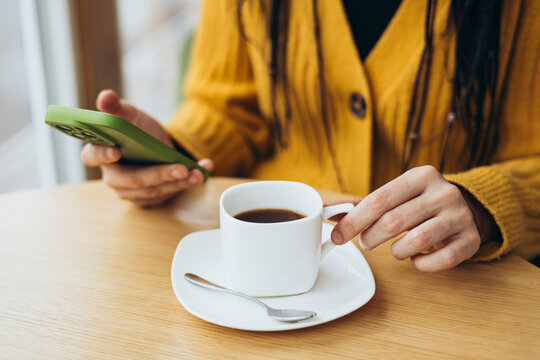 Cozy moment with coffee and smartphone at wooden table