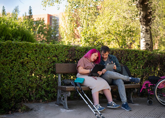 College couple studying outside, highlighting disability inclusion