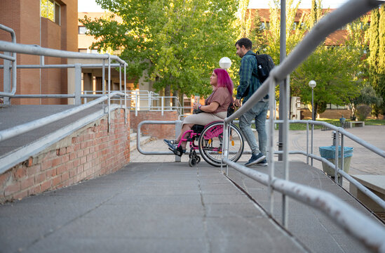 College couple navigating campus with wheelchair access