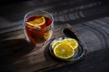 Aromatic English tea with fresh lemon slices on wooden table