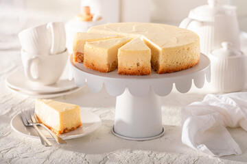 Tasty New york cheesecake served on white table.