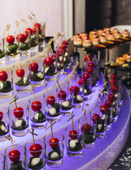 Catering table, beautifully decorated banquet with variety different food snacks appetizers on christmas corporate birthday party event or wedding celebration, canape, salad, delicatessen setting