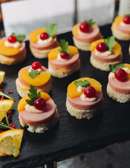 Catering table, beautifully decorated banquet with variety different food snacks appetizers on christmas corporate birthday party event or wedding celebration, canape, salad, delicatessen setting