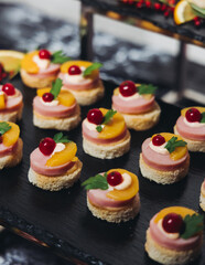 Catering table, beautifully decorated banquet with variety different food snacks appetizers on christmas corporate birthday party event or wedding celebration, canape, salad, delicatessen setting