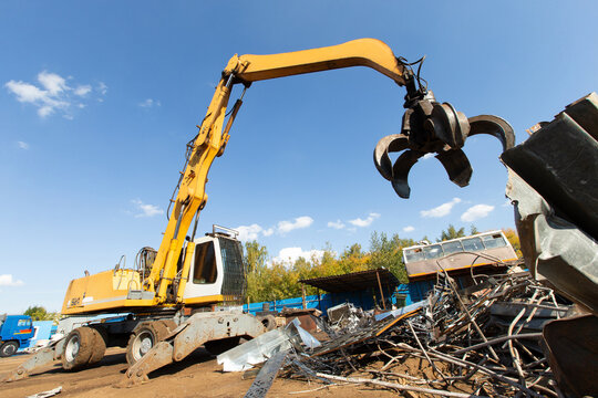 Excavator for loading scrap metal.
